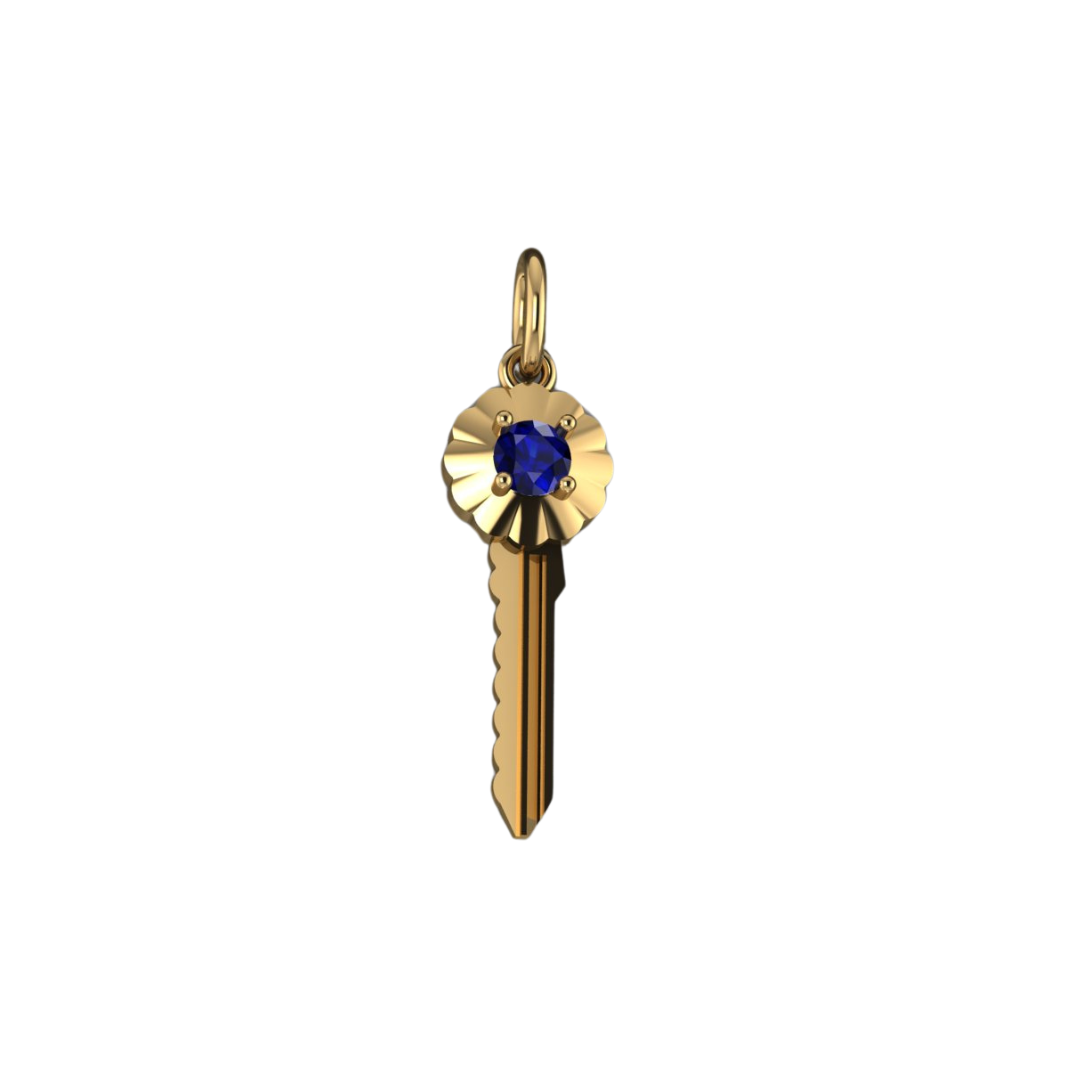 A yellow gold key-shaped pendant with a large blue sapphire at the top center, set in a scalloped design.