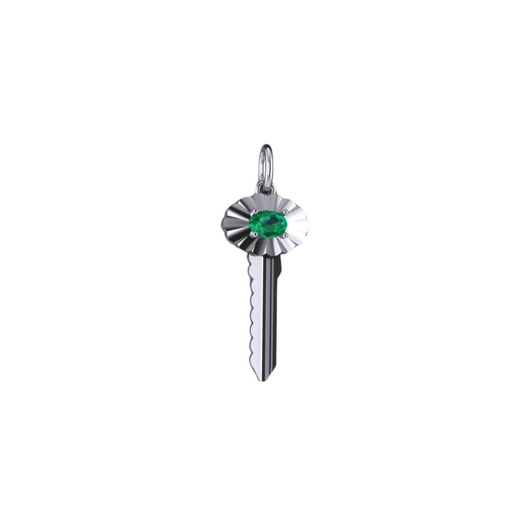 A white gold key-shaped pendant with a scalloped frame and a central oval-cut emerald.