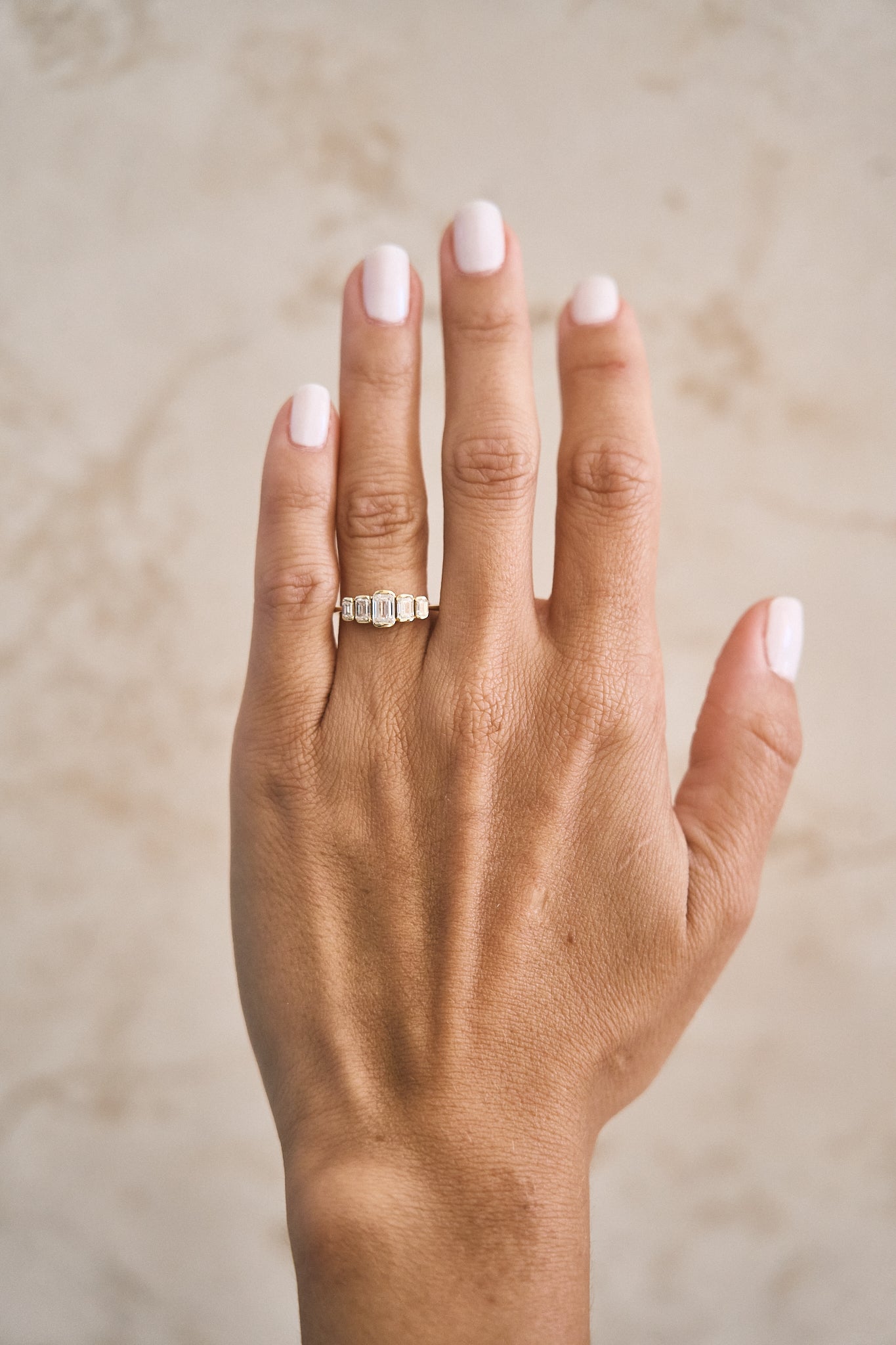 Graduated Emerald Diamond Bezel Diamond Ring