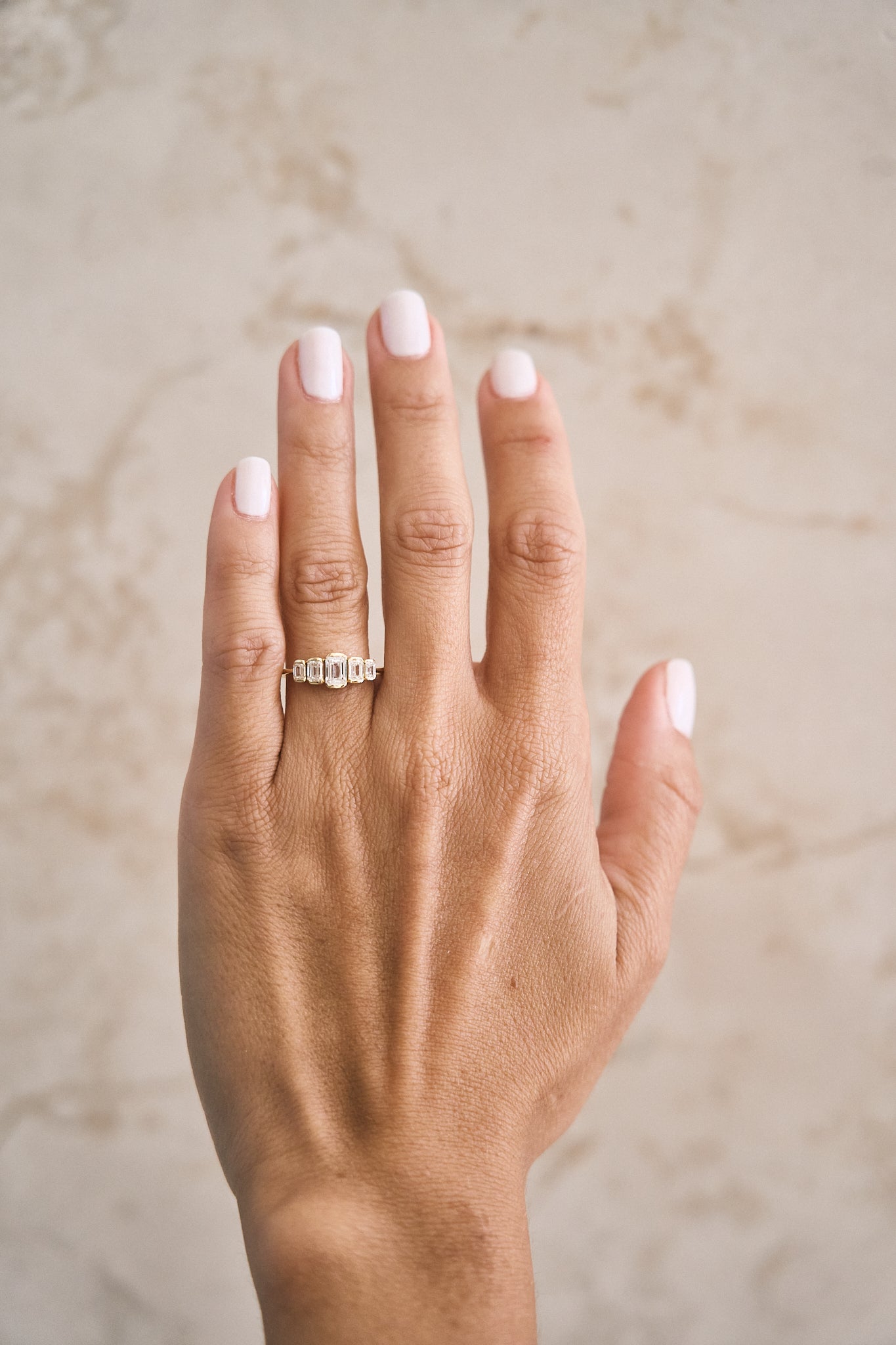 Graduated Emerald Diamond Bezel Diamond Ring