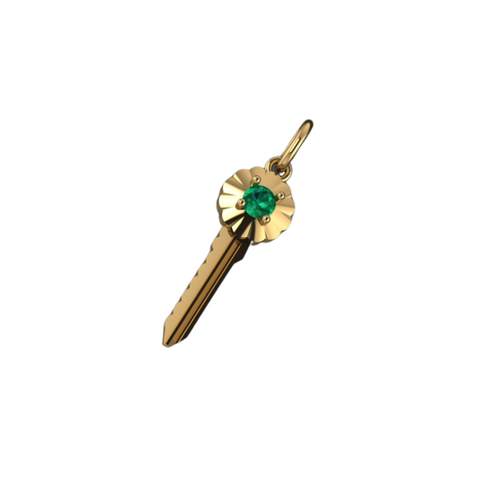 Gold key-shaped pendant with a green gemstone on a white background