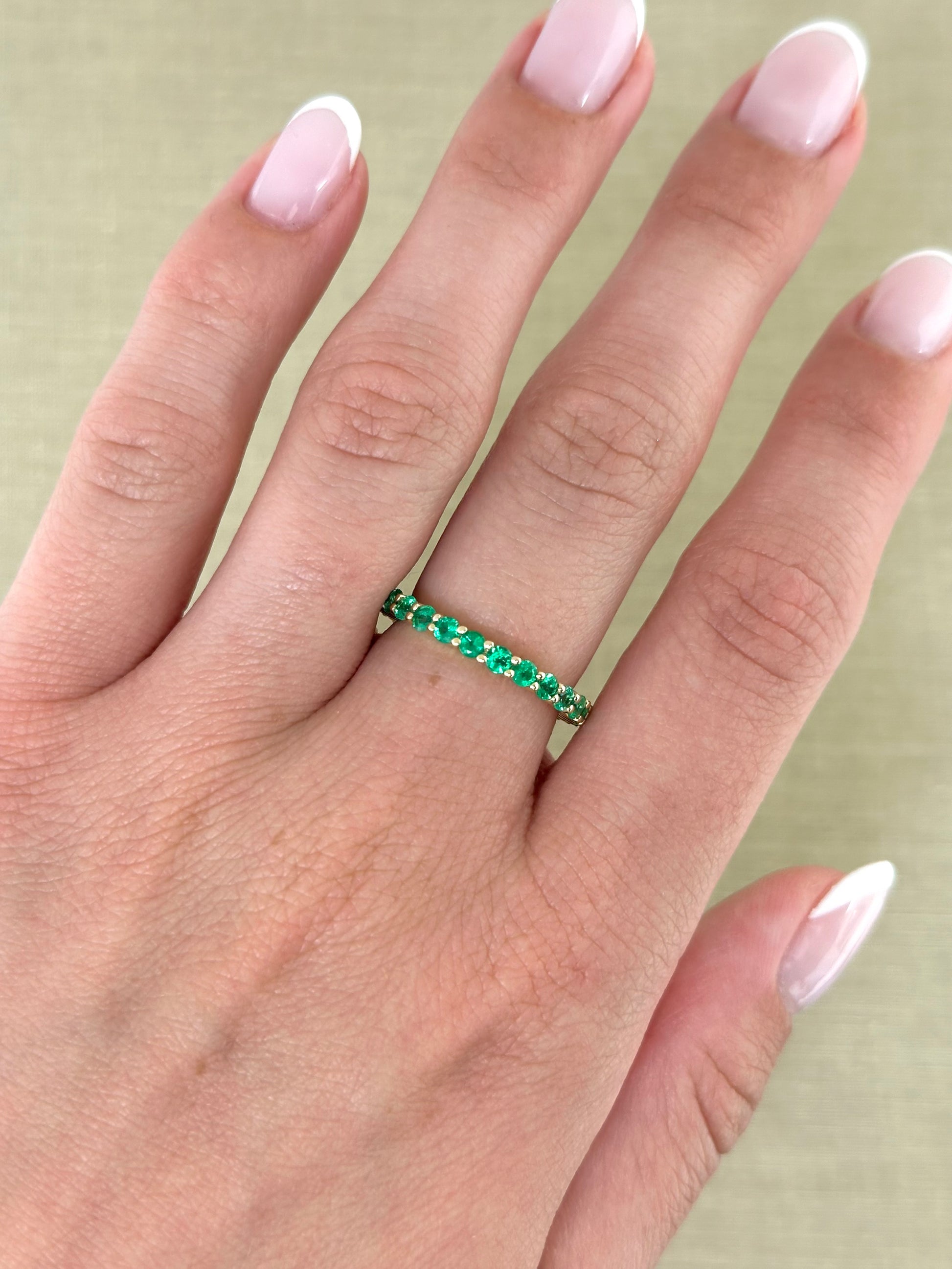 Round Emerald Eternity Band – Henri Noël