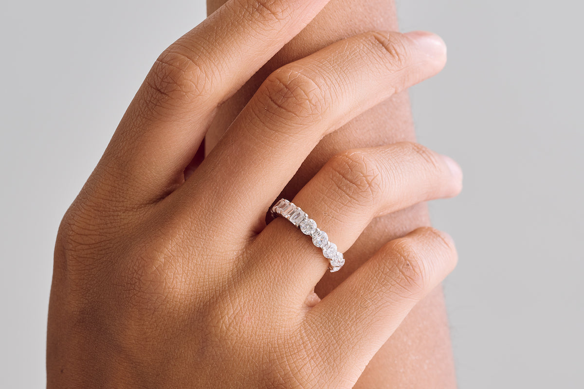 Half Round & Half Emerald Eternity Band – Henri Noël